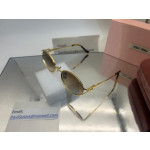 Miu Miu Gold-colored frame Metal Oval Sunglasses